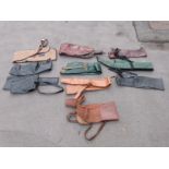 Ten various gun slips / cases, some leather and some padded.
