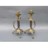 A pair of Victorian novelty candlesticks formed as sword handles,