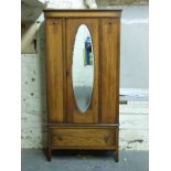 An oak single wardrobe with oval bevelled glass mirror,