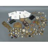 A collection of military metal and cloth badges, buttons, two identity tags for H D Smith 14316927,