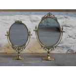 Two oval brass swing frame mirrors,