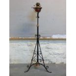 A 19thC Arts and Crafts style Evered & Co copper and brass oil lamp on wrought iron adjustable