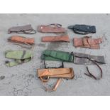 Ten various gun slips / cases, some leather and some padded.