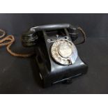 A black bakelite vintage telephone,