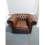 A Chesterfield brown leather chair