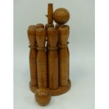 A vintage turned wooden skittles game