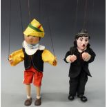 Two vintage puppets Pinocchio and Charlie Chaplin each approximately 30cm tall excluding wires.