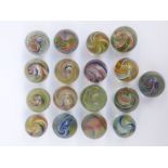 Seventeen handmade glass marbles all with multi-coloured latticino decoration,