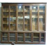 A large glazed oak bookcase, the top three sections each with double doors and adjustable shelves,
