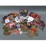 A collection of various mostly military cloth insignia badges of rank, formations,