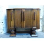 An Ercol Art Deco style dining suite comprising extending table and chairs and sideboard,