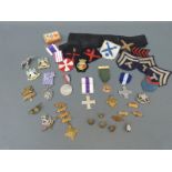 A quantity of militaria including cap badges for Notts & Derby, West Riding, Buffs etc,