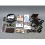 A collection of gun or shooting accessories including Oakley shooting glasses with multiple lenses,