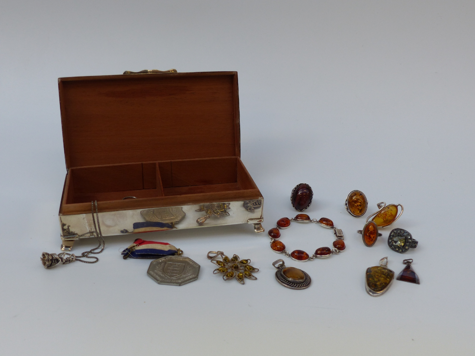 A collection of silver jewellery set with pressed amber,