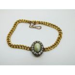A 19thC 18ct gold French curb link bracelet set with a chrysoberyl cat's eye cabochon surrounded by