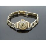 An 18ct gold ladies wristwatch with blued hands, black Arabic numerals and gold face,