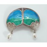 A silver brooch set with green and blue enamel with two drop pearls by Liberty and Co,