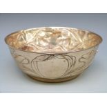 A silver plated or similar bowl with floral decoration,