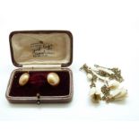 A pair of 9ct gold earrings each set with a faux pearl,