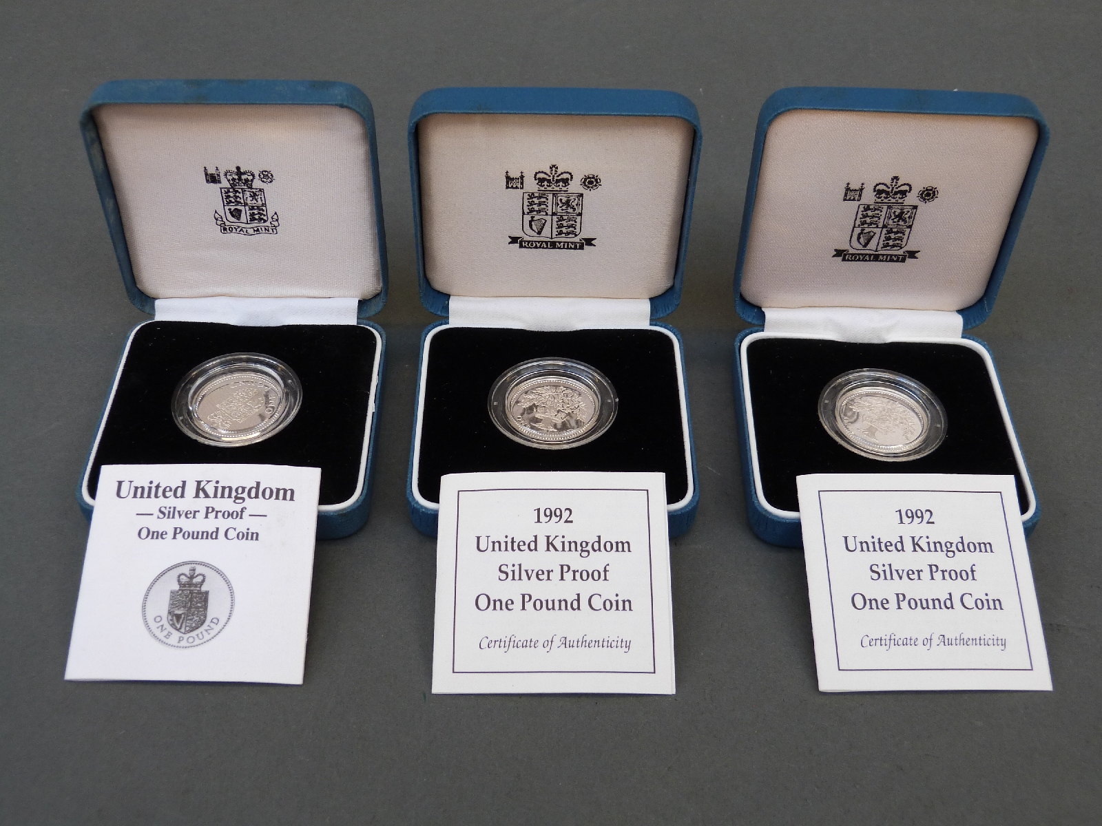 Three Royal Mint UK silver proof cased £1 coins one for 1988, the other two 1992,