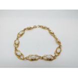 A 9ct gold bracelet set with white opals, 5.