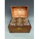 A Georgian mahogany travelling case of six gilt apothecary or similar bottles, each 20cm tall,