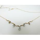 A 9ct gold necklace set with pear cut blue topaz and diamonds