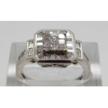 An 18ct white gold ring set with square and baguette cut diamonds, size O,