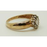 A 9ct gold ring set with a square cut diamond surrounded by round cut diamonds, 2.