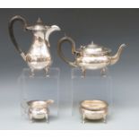 A George V hallmarked silver four piece tea service comprising teapot, hot water jug,