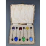 A cased set of six hallmarked silver and guilloché enamel coffee bean spoons,