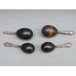 Four various white metal and hallmarked silver ebony darning or sewing eggs,