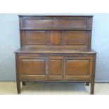 An oak sideboard with panelled back and doors,