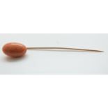 A Victorian stick pin set with a coral cabochon