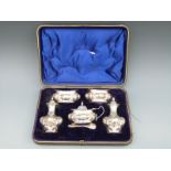A cased Victorian / Edward VII hallmarked silver five piece cruet set, various dates c1900 to 1903,