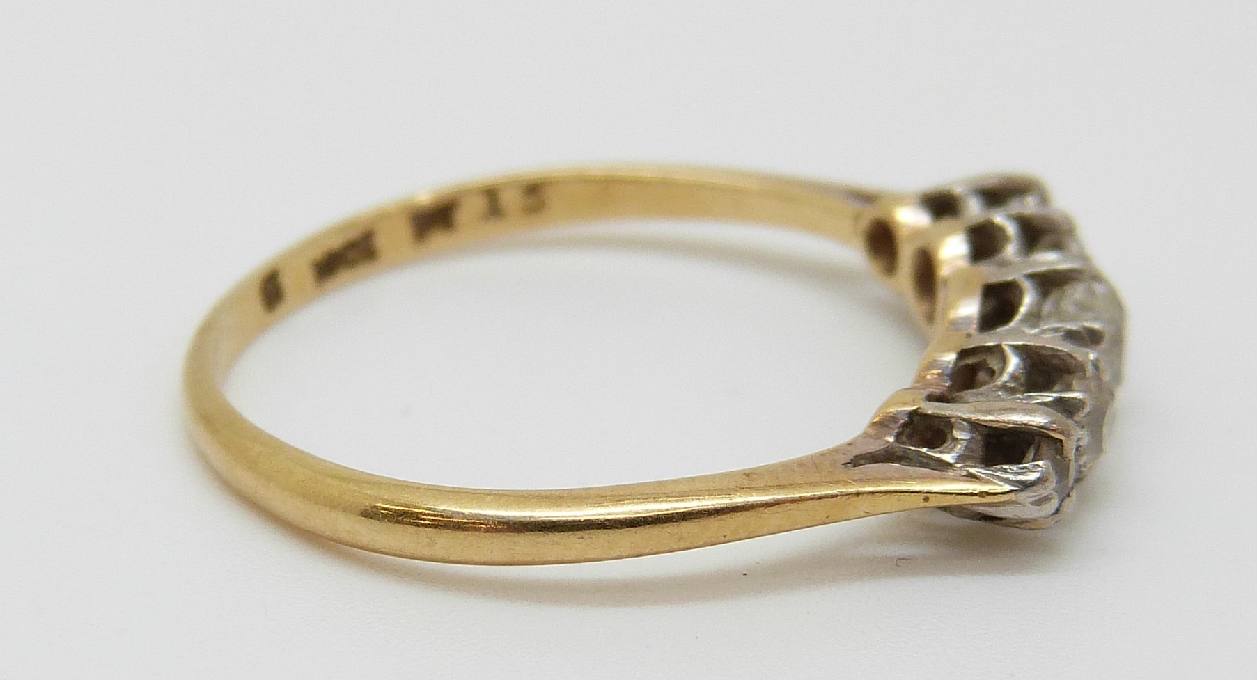 An 18ct gold ring set with five old cut diamonds in a platinum setting, - Image 2 of 3
