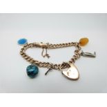 A 9ct gold curb link bracelet with turquoise charm, a 9ct gold heart padlock etc,