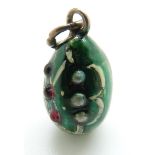 A silver egg pendant set with red cabochons and seed pearls,