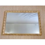 A bevelled glass mirror with decorative gilt moulded frame,