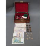 A wooden chest / caddy containing some crown sized coins including silver Britannia,