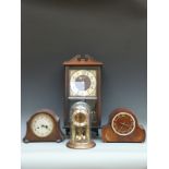 Two oak-cased mantel clocks, one a Smiths Enfield example,