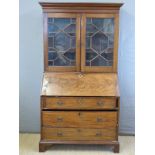 A Georgian flame mahogany bureau having fitted interior,