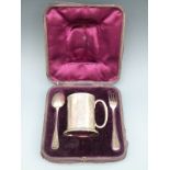 A cased Victorian hallmarked silver christening set comprising tankard, spoon and fork,