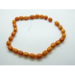 A Baltic amber necklace of 28 oval beads the largest approximately 1.6 x 1.