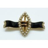 A 15ct gold Edwardian brooch in the form of a buckle set with seed pearls and black enamel