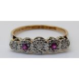 An 18ct gold ring set with rubies and diamonds in a platinum setting, size J/K, 2.