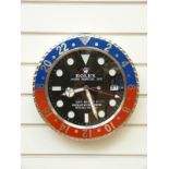 Rolex advertising wall clock with blue and red bezel surround,