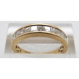 An 18ct gold ring set with 11 princess cut diamonds, size O, 4.