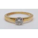 An 18ct gold ring set with a round cut diamond of approximately 0.