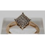 A 10k gold ring set with square cut diamonds in a square shaped setting, size N, 2.